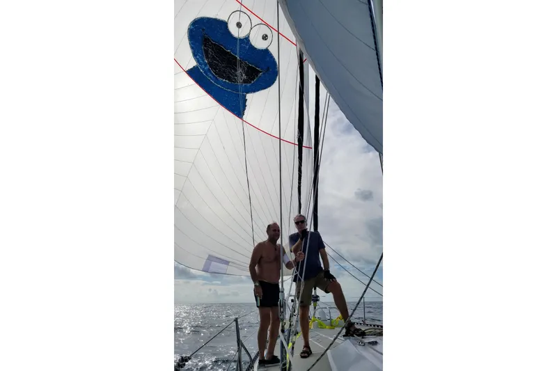 Slide: The Image of Two people sailing on 1982 Tayana Center Cockpit Cutter Ketch with a playful sail design. - 24