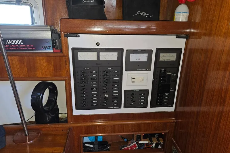 Slide: The Image of Electrical panel inside 1982 Tayana Center Cockpit Cutter Ketch, featuring gauges and switches. - 31