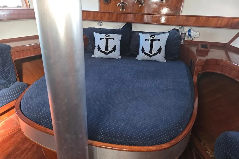 Slide: The Image of Cozy cabin interior of 1982 Tayana Center Cockpit Cutter Ketch with nautical-themed pillows. - 38