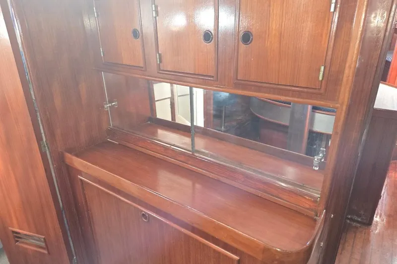 Slide: The Image of Wooden interior of 1982 Tayana Center Cockpit Cutter Ketch, featuring cabinets and mirror. - 43