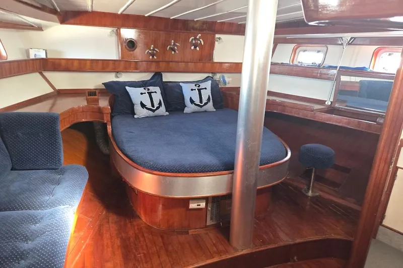 Slide: The Image of Interior of 1982 Tayana Center Cockpit Cutter Ketch with cozy bed and nautical decor. - 5