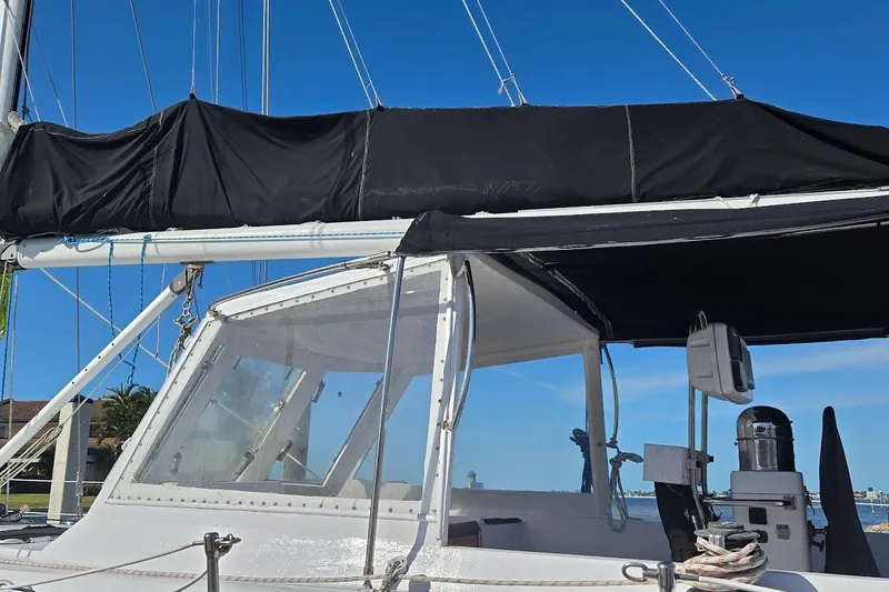 Slide: The Image of 1982 Tayana Center Cockpit Cutter Ketch with black sail cover and clear cockpit enclosure. - 58