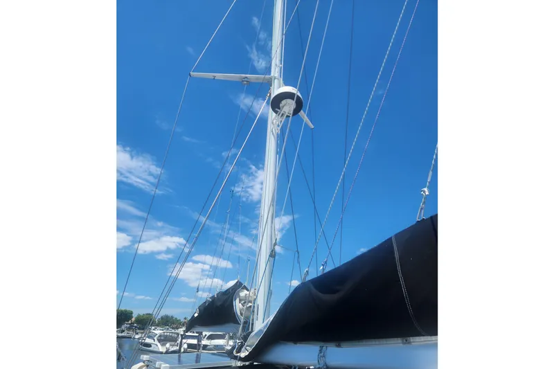 Slide: The Image of 1982 Tayana Center Cockpit Cutter Ketch mast against a clear blue sky. - 64