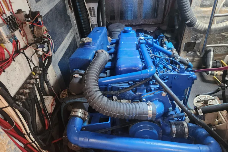 Slide: The Image of Engine room of 1982 Tayana Center Cockpit Cutter Ketch with blue-painted engine components. - 75