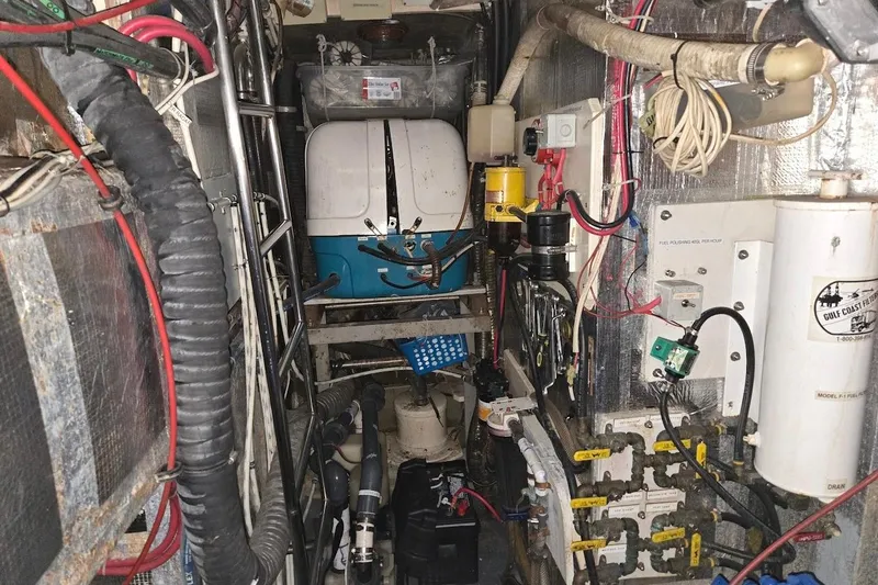 Slide: The Image of Engine room of 1982 Tayana Center Cockpit Cutter Ketch with various mechanical components. - 78