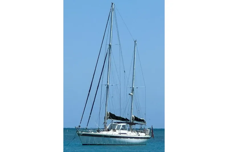 Slide: The Image of 1982 Tayana Center Cockpit Cutter Ketch sailing on calm blue waters. - 83