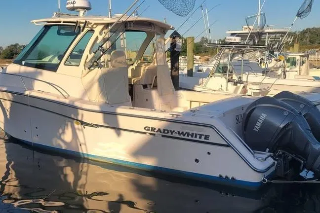 The Image of 2013 Grady-White Express 330 boat with Yamaha engines docked in marina. - 0