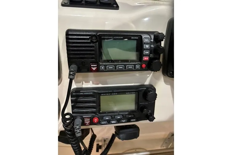 Slide: The Image of Dual Standard Horizon marine radios on 2013 Grady-White Express 330 boat dashboard. - 11
