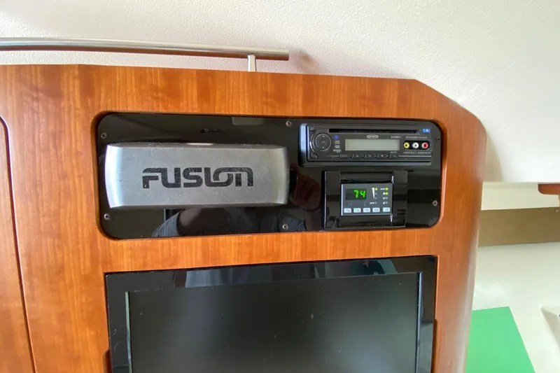 Slide: The Image of Fusion audio system and control panel in 2013 Grady-White Express 330 boat interior. - 13