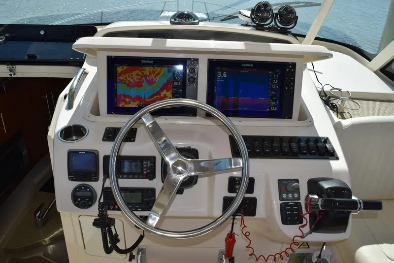 Slide: The Image of Helm of 2013 Grady-White Express 330 with navigation displays and controls. - 18