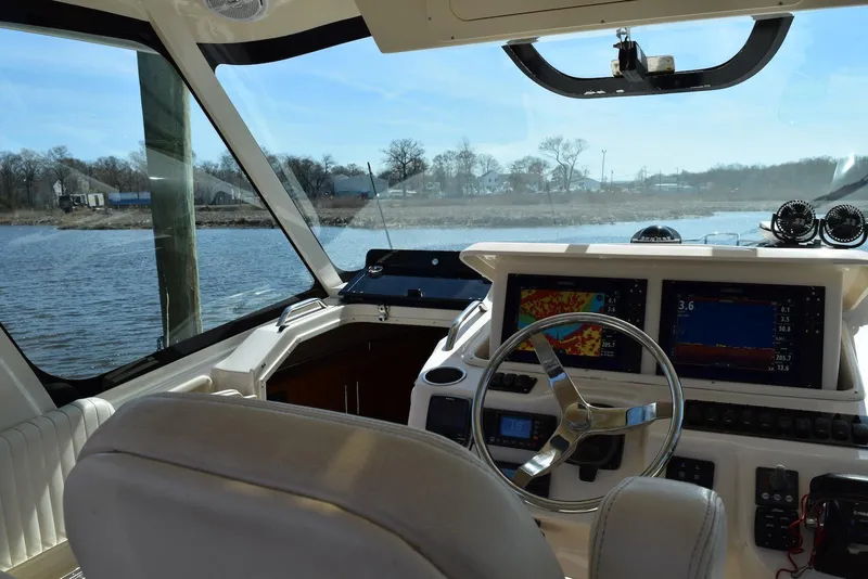 Slide: The Image of Interior view of 2013 Grady-White Express 330 boat cockpit with navigation screens. - 19