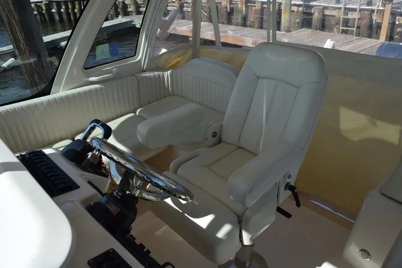 Slide: The Image of Interior of 2013 Grady-White Express 330 boat with steering wheel and seating. - 22