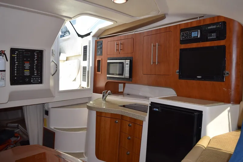 Slide: The Image of Interior of 2013 Grady-White Express 330 boat with kitchenette and modern amenities. - 24
