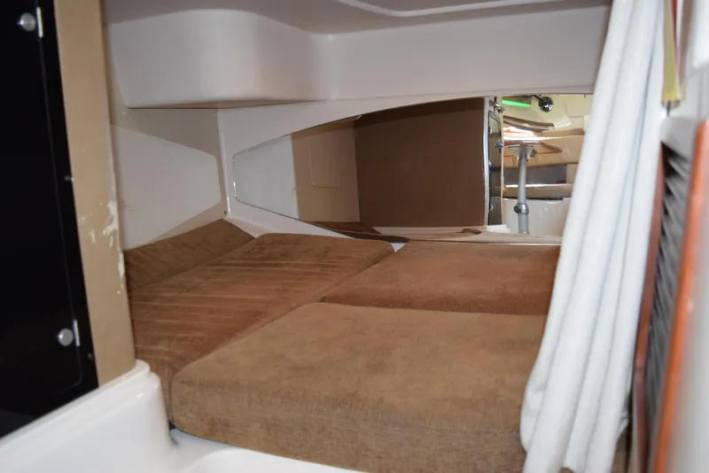 Slide: The Image of 2013 Grady-White Express 330 cabin interior with cozy brown bedding. - 26