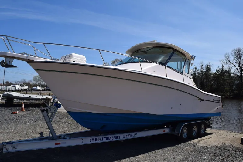 Slide: The Image of 2013 Grady-White Express 330 boat on trailer by waterfront. - 28