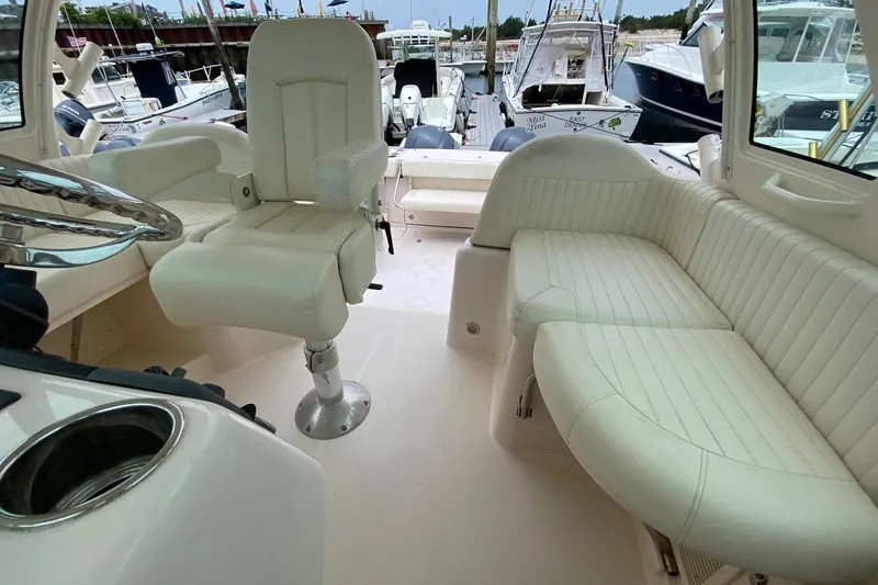 Slide: The Image of 2013 Grady-White Express 330 boat interior with white seating and helm chair. - 3