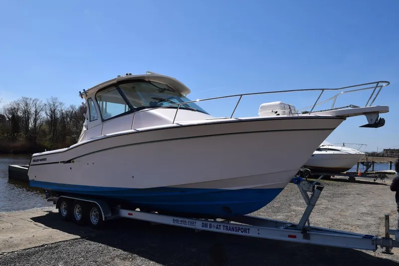 Slide: The Image of 2013 Grady-White Express 330 boat on trailer by waterfront. - 30