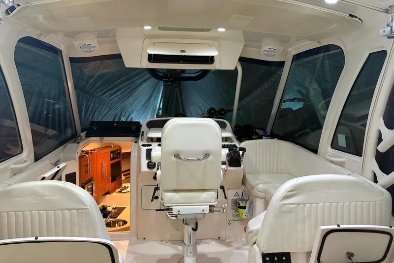 Slide: The Image of Interior of 2013 Grady-White Express 330 boat with helm and seating area. - 4