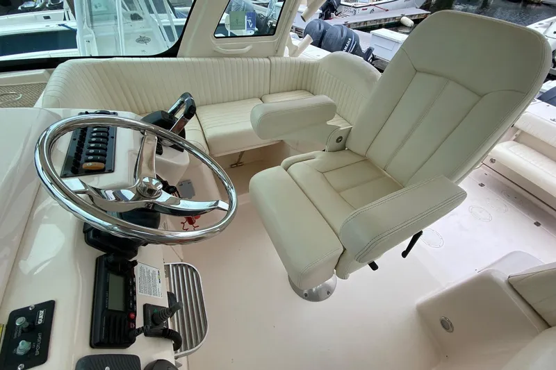 Slide: The Image of Interior of 2013 Grady-White Express 330 boat with steering wheel and captain's chair. - 5