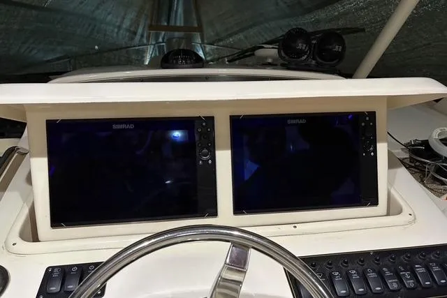 Slide: The Image of Helm of 2013 Grady-White Express 330 with dual Simrad displays and control panel. - 6