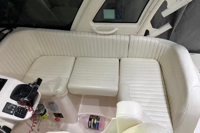 Slide: The Image of 2013 Grady-White Express 330 boat interior with white cushioned seating. - 8
