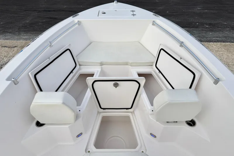 Slide: The Image of 2023 Aquasport 220 CC boat interior with storage compartments and seating. - 10