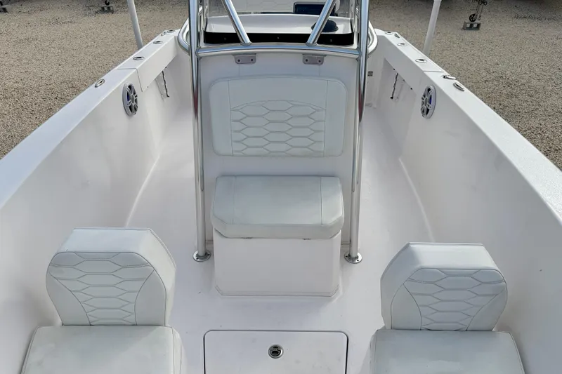 Slide: The Image of 2023 Aquasport 220 CC boat interior with white seating and sleek design. - 13