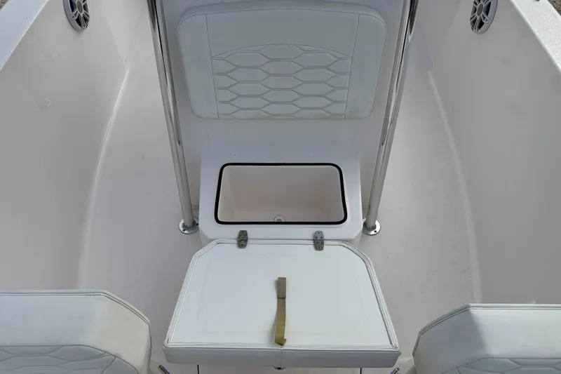 Slide: The Image of 2023 Aquasport 220 CC boat interior with seating and storage compartment. - 14