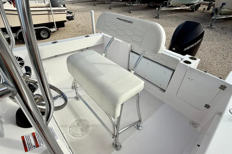 Slide: The Image of 2023 Aquasport 220 CC boat interior with seating and Mercury engine. - 16