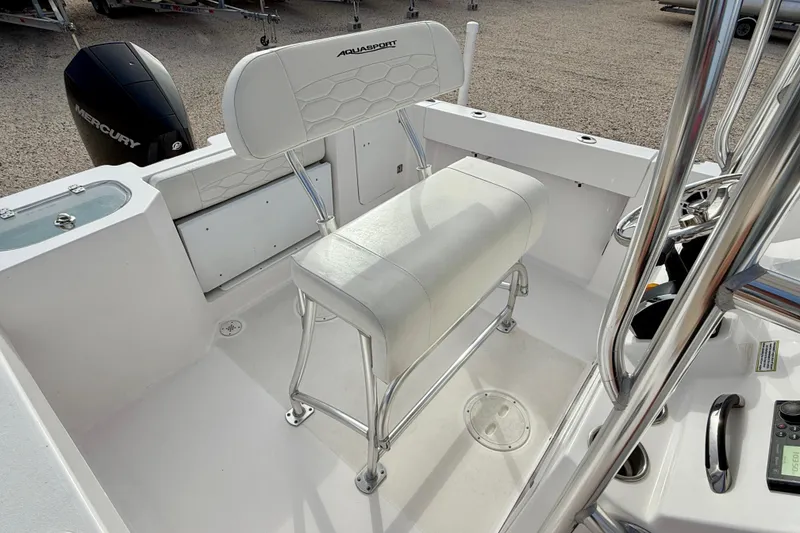 Slide: The Image of 2023 Aquasport 220 CC boat interior with seating and Mercury engine. - 17