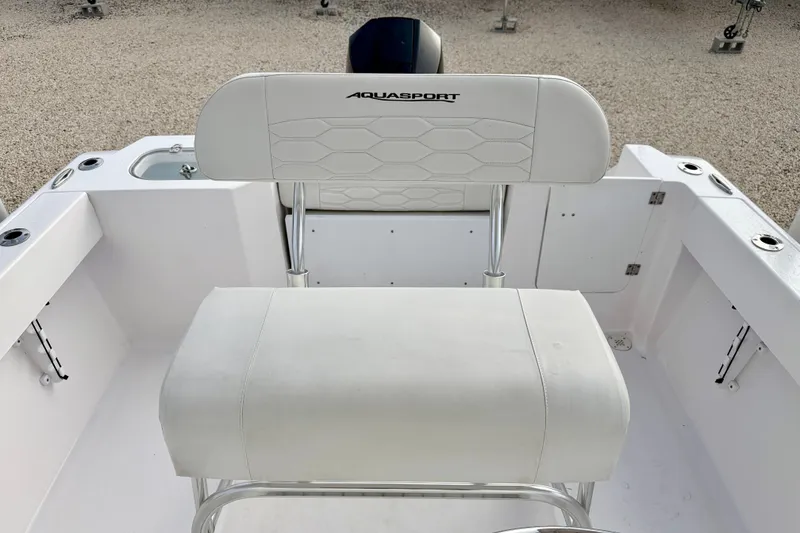 Slide: The Image of 2023 Aquasport 220 CC boat seating with white upholstery and sleek design. - 18