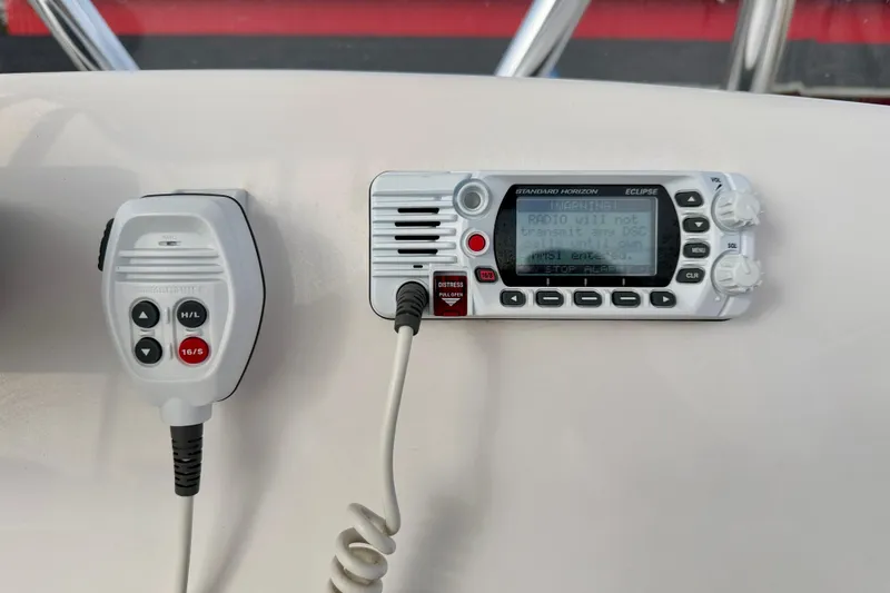 Slide: The Image of VHF radio system on 2023 Aquasport 220 CC boat dashboard. - 23