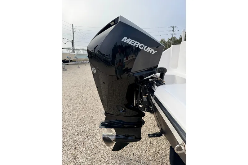 Slide: The Image of 2023 Aquasport 220 CC with Mercury outboard motor, displayed on gravel lot. - 33