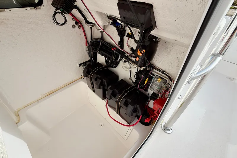 Slide: The Image of 2023 Aquasport 220 CC boat interior wiring and battery compartment. - 35
