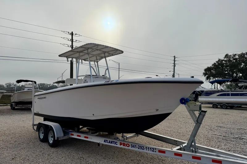 Slide: The Image of 2023 Aquasport 220 CC boat on trailer under cloudy sky. - 4