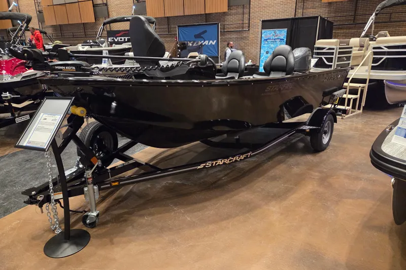 The Image of 2026 Starcraft Starfire 160 SC boat on display, featuring sleek black design and trailer. - 1