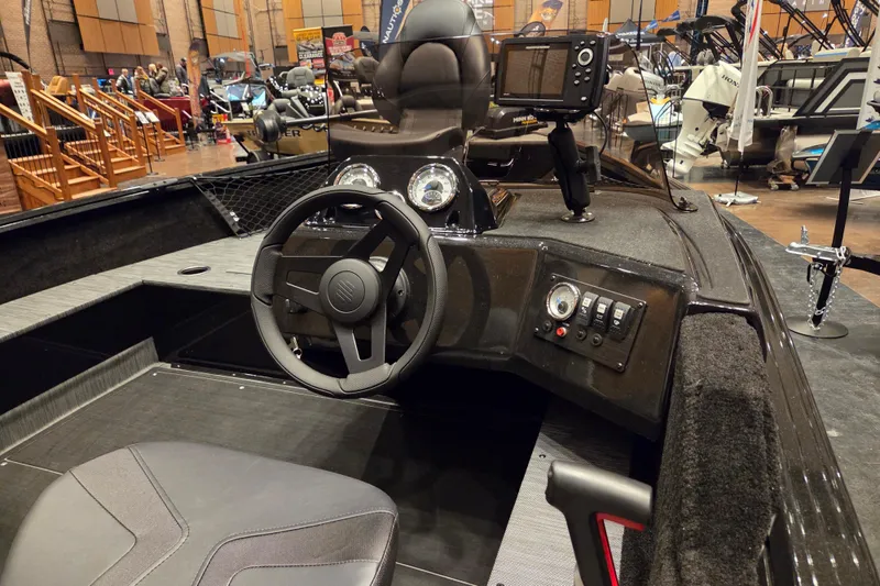 Slide: The Image of 2026 Starcraft Starfire 160 SC boat interior with steering wheel and control panel. - 5