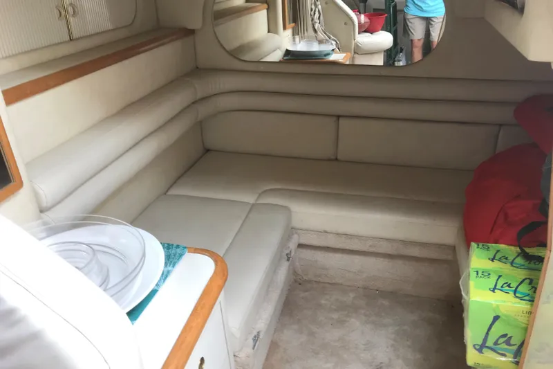 Slide: The Image of Interior of 1997 Sea Ray Sundancer 330 with beige seating and storage space. - 14