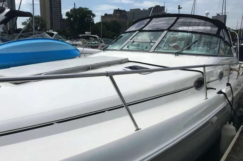 Slide: The Image of 1997 Sea Ray Sundancer 330 yacht docked in marina, featuring sleek white design. - 15