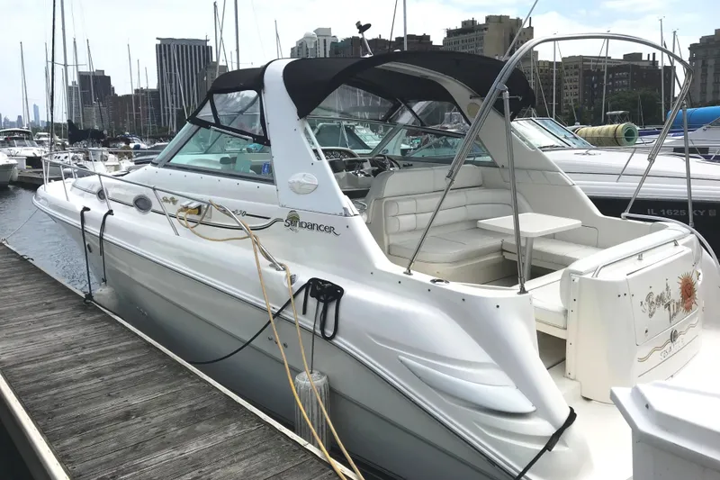 Slide: The Image of 1997 Sea Ray Sundancer 330 docked at marina, featuring sleek design and spacious seating. - 4