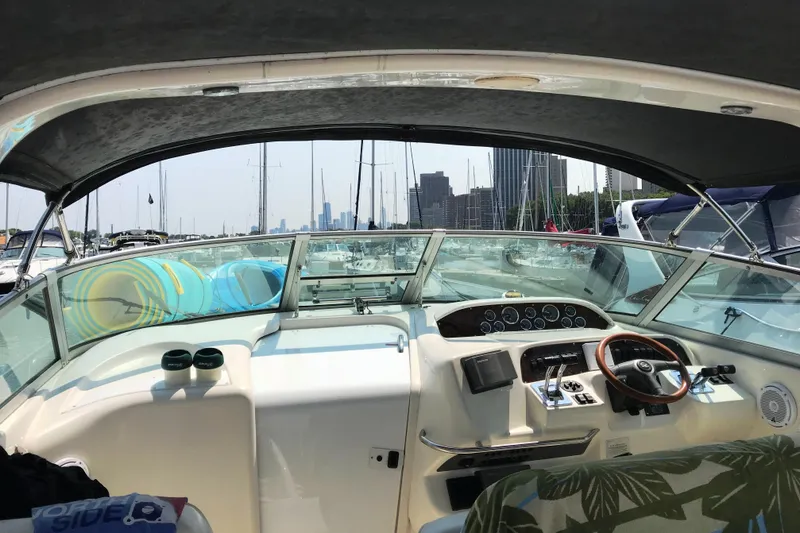 Slide: The Image of 1997 Sea Ray Sundancer 330 cockpit view with city skyline in the background. - 5