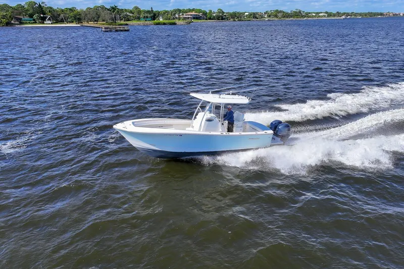 Slide: The Image of Aerial view of 2014 Regulator 25 boat cruising on open water. - 12
