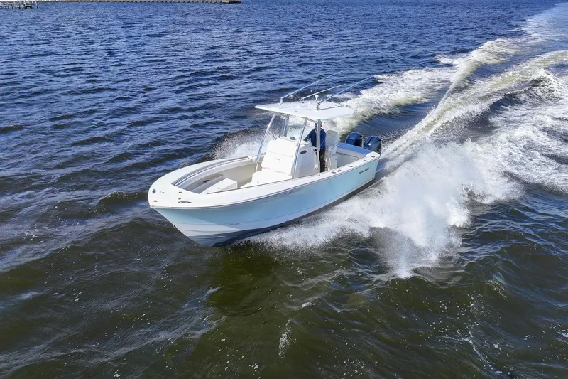 Slide: The Image of 2014 Regulator 25 boat cruising on open water, aerial view. - 13