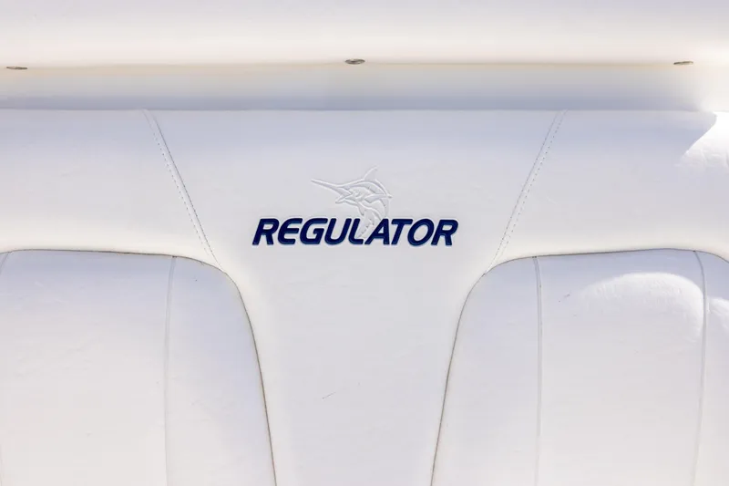 Slide: The Image of 2014 Regulator 25 boat with stainless steel rod holders and storage compartments. - 26