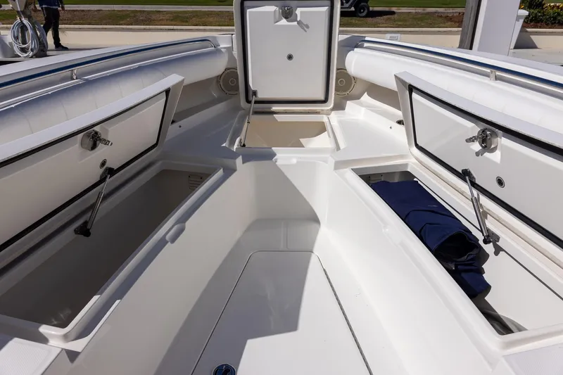 Slide: The Image of 2014 Regulator 25 boat interior with open storage compartments and seating. - 41