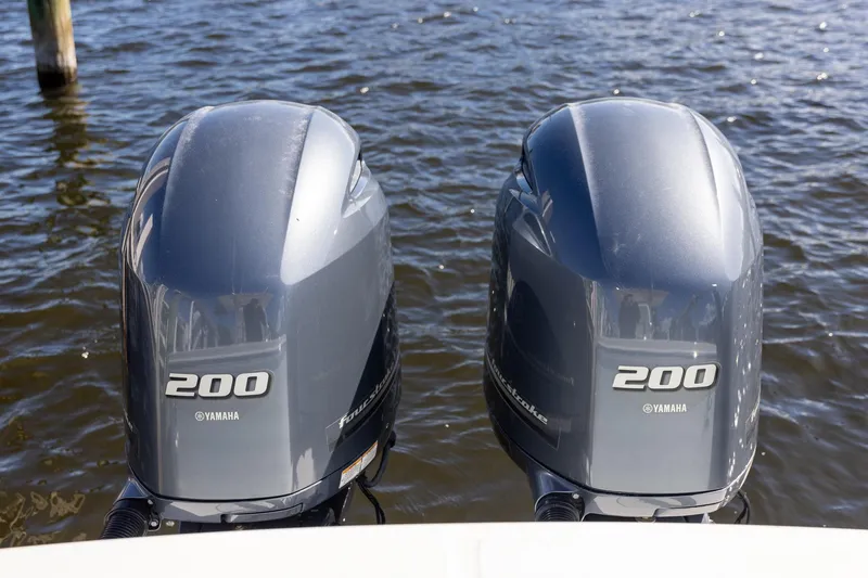 Slide: The Image of Twin Yamaha 200 outboard engines on a 2014 Regulator 25 boat, floating on water. - 43