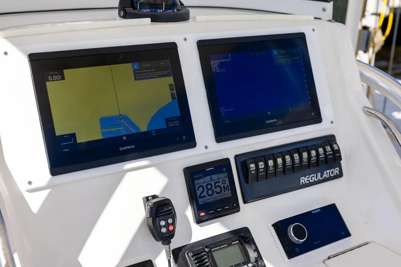 Slide: The Image of Control panel of a 2014 Regulator 25 boat with Garmin navigation displays. - 45