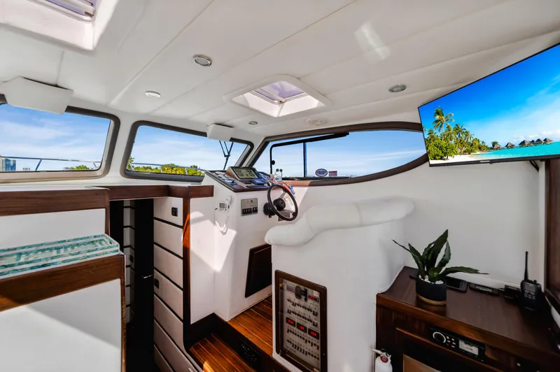Slide: The Image of Interior of 2007 Custom NNS Sea Scout 41 yacht with modern helm and tropical view. - 16