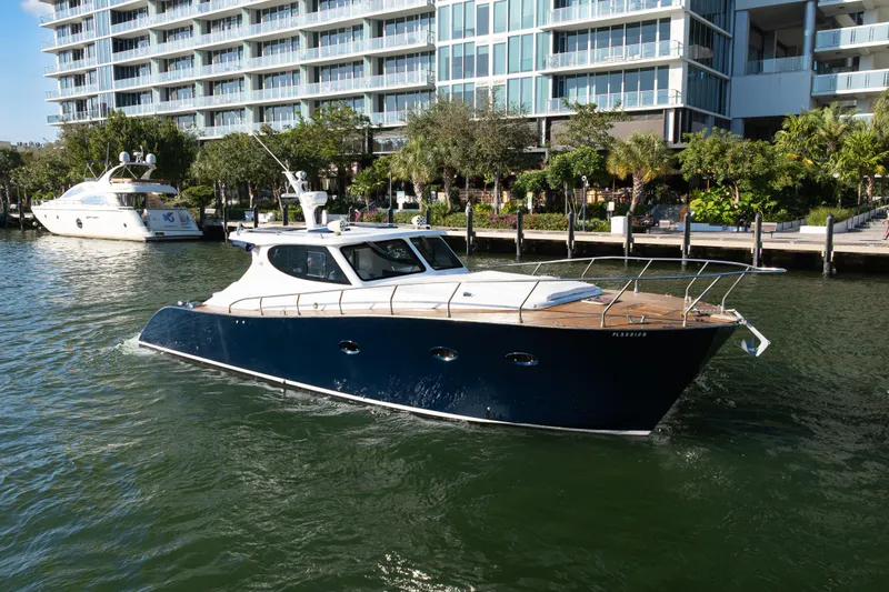 Slide: The Image of Custom NNS Sea Scout 41 yacht, 2007 model, cruising near waterfront buildings. - 2