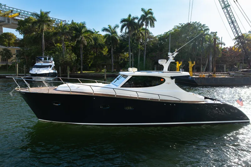 Slide: The Image of Custom 2007 NNS Sea Scout 41 yacht cruising on a sunny day, surrounded by palm trees. - 6